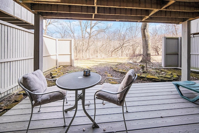 wooden terrace featuring fence