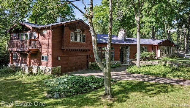 28190 Wildwood Trl, Farmington Hills, MI 48336 - view of front of house with a chimney, driveway, an attached garage, and a front lawn