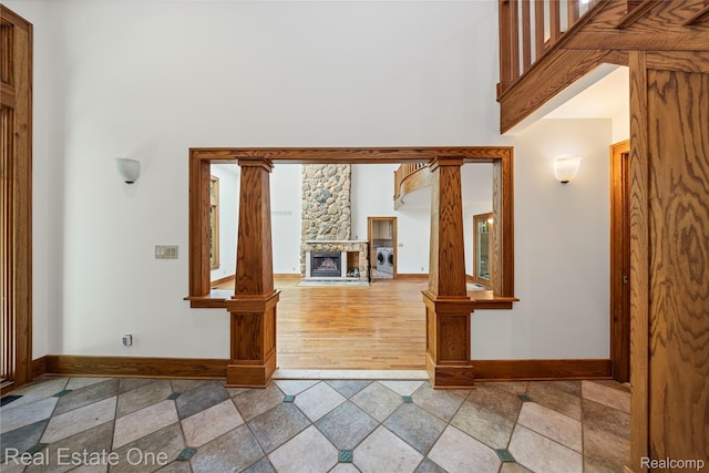 28190 Wildwood Trl, Farmington Hills, MI 48336 - entrance foyer with a stone fireplace, a towering ceiling, stone finish floors, and washer / dryer