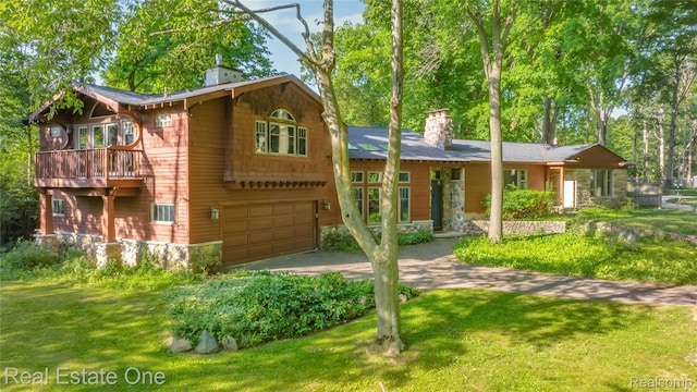 28190 Wildwood Trl, Farmington Hills, MI 48336 - view of front facade featuring a chimney, driveway, a garage, and a front lawn