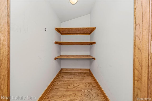 28190 Wildwood Trl, Farmington Hills, MI 48336 - walk in closet featuring vaulted ceiling and light wood-style flooring