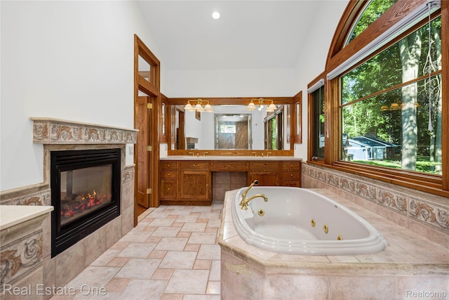 28190 Wildwood Trl, Farmington Hills, MI 48336 - full bath featuring vanity, a whirlpool tub, a glass covered fireplace, plenty of natural light, and lofted ceiling