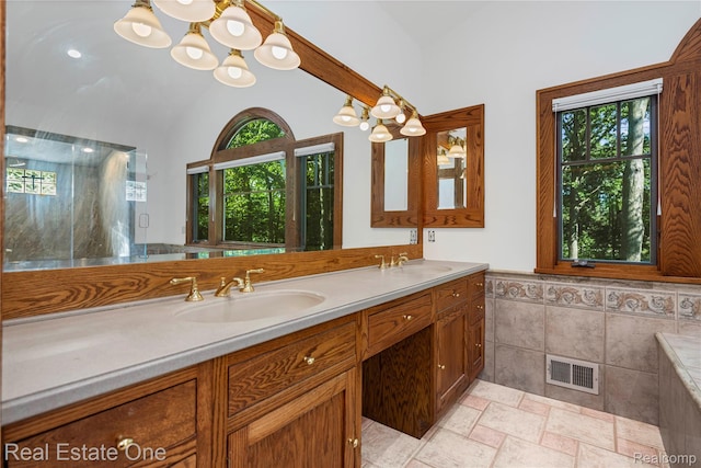 28190 Wildwood Trl, Farmington Hills, MI 48336 - bathroom with lofted ceiling, double vanity, a chandelier, tile walls, and wainscoting