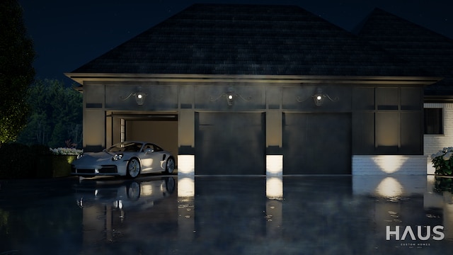 1644 Vista Dr, Oakland, MI 48363 - garage at night featuring concrete driveway