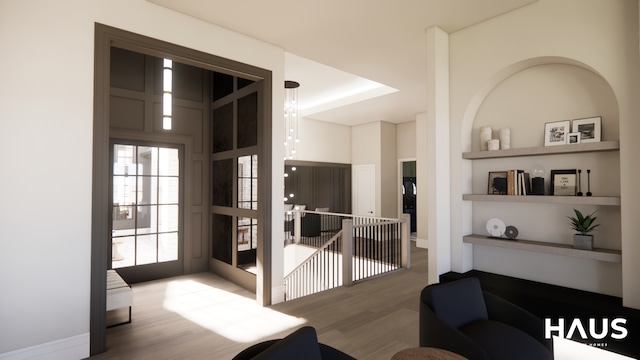 1644 Vista Dr, Oakland, MI 48363 - living room featuring built in shelves, wood finished floors, and a towering ceiling
