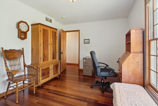 office with dark wood-type flooring, baseboards, and visible vents