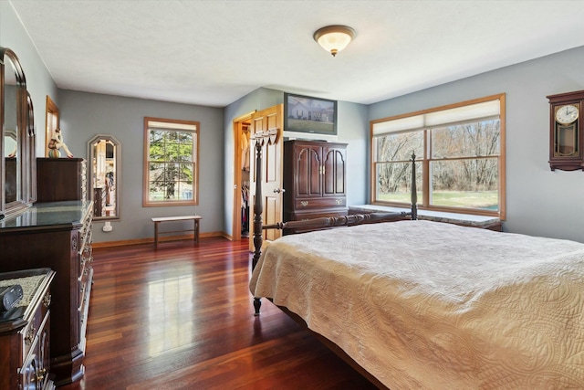 bedroom featuring dark wood-style floors and baseboards