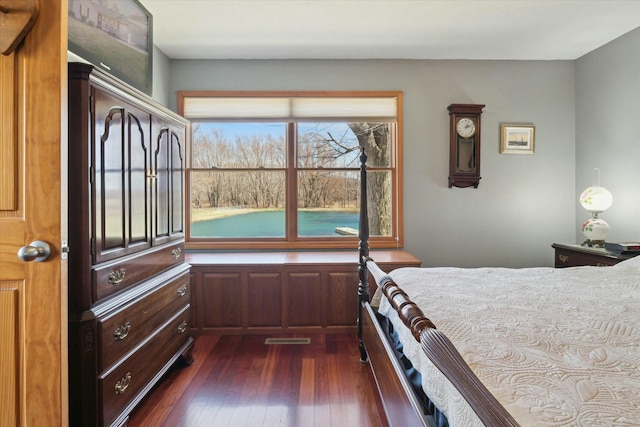 unfurnished bedroom featuring dark wood-style floors and visible vents