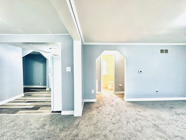 bonus room with visible vents, baseboards, arched walkways, and carpet floors