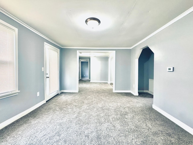 unfurnished room featuring carpet, baseboards, and crown molding