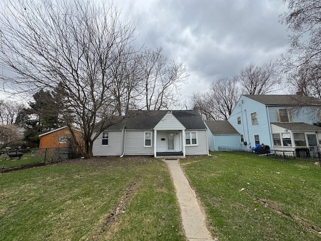 bungalow featuring a front yard and fence