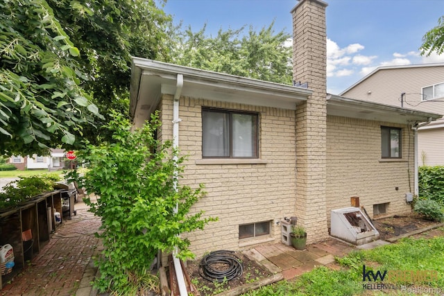 22180 Boulder Ave, Eastpointe, MI 48021 - rear view of property featuring brick siding and a chimney