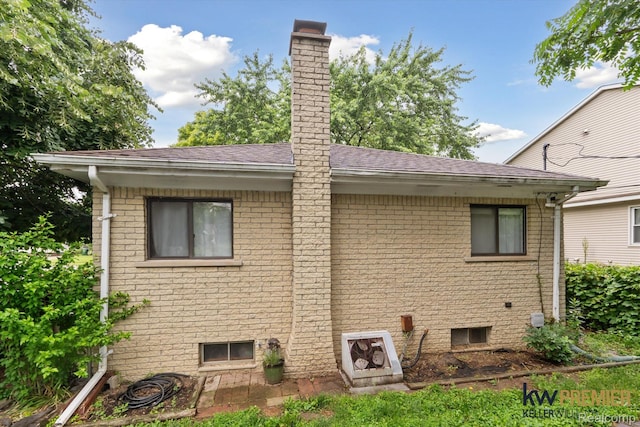 22180 Boulder Ave, Eastpointe, MI 48021 - back of house with a chimney, roof with shingles, and brick siding