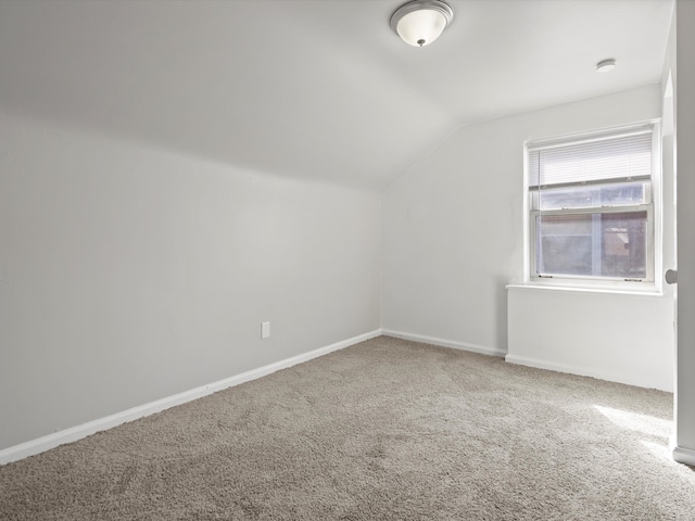additional living space with baseboards, carpet floors, and lofted ceiling