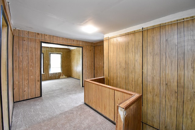 interior space featuring wooden walls and carpet floors