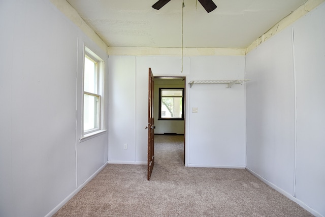 empty room with baseboards, ceiling fan, and carpet floors