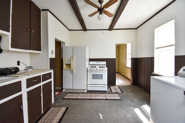 kitchen with white appliances, a ceiling fan, a wainscoted wall, washer / dryer, and beamed ceiling