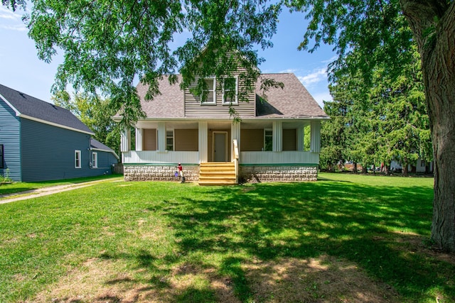 view of front of property with a porch, a front lawn, and roof with shingles