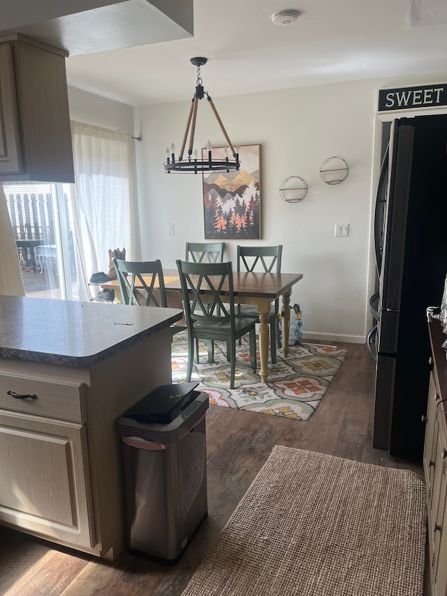dining space with baseboards, dark wood-type flooring, and a chandelier