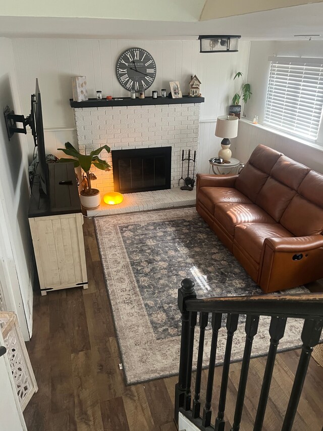 living room with dark wood-style floors and a fireplace