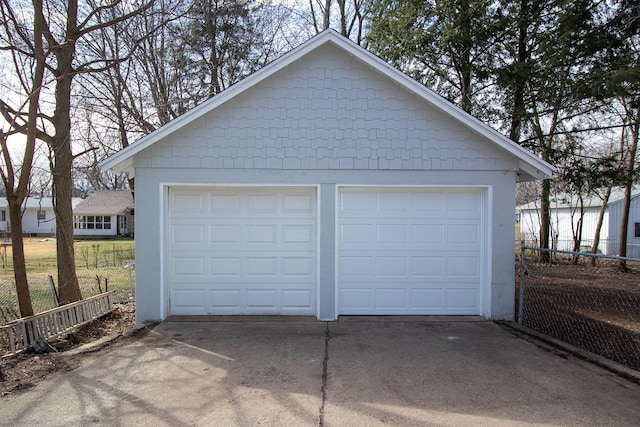 detached garage featuring fence