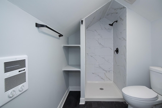 full bath with a shower stall, baseboards, toilet, wood finished floors, and heating unit