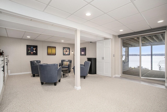 carpeted living area with recessed lighting, a drop ceiling, and baseboards