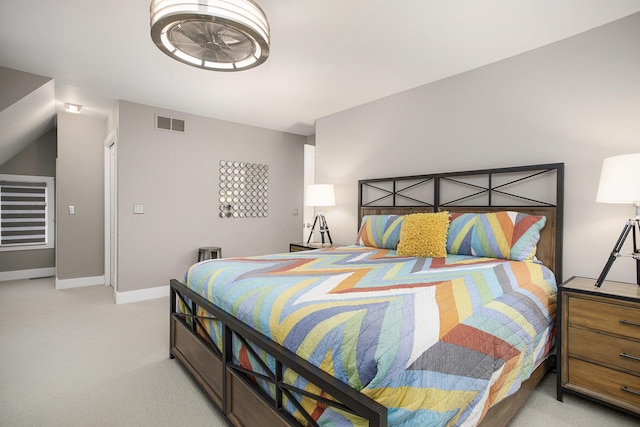 bedroom with light colored carpet, visible vents, and baseboards