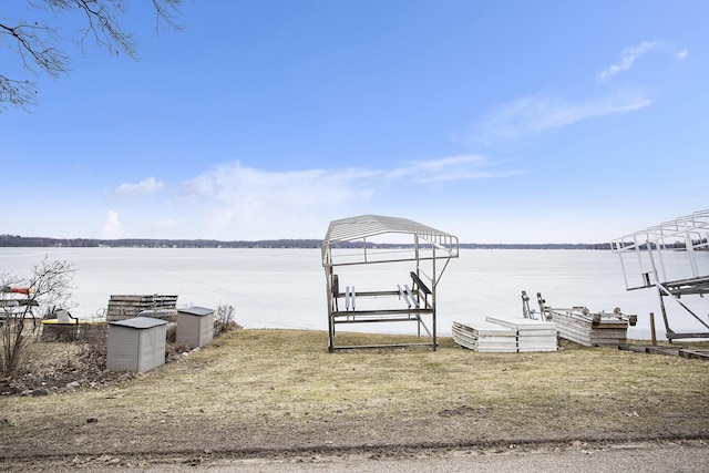 view of dock with boat lift and a water view