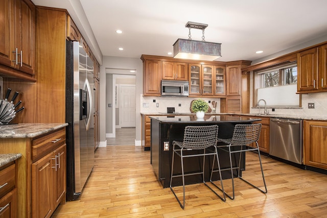 kitchen featuring brown cabinets and appliances with stainless steel finishes