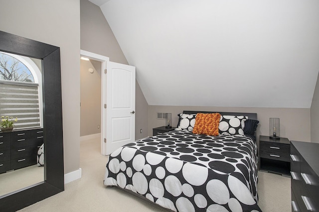 bedroom featuring light carpet, visible vents, baseboards, and lofted ceiling