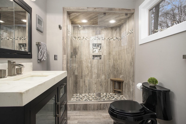 full bath featuring recessed lighting, vanity, and a shower stall