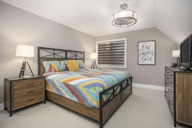 bedroom with light carpet, baseboards, and vaulted ceiling