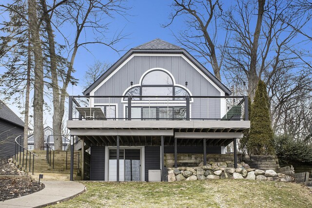 view of front facade with a deck and a front yard