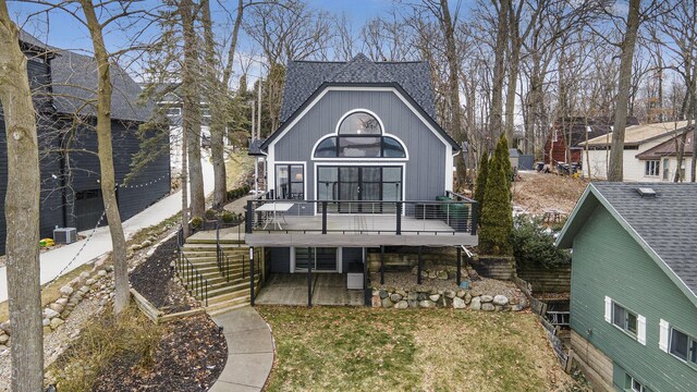 rear view of house featuring a wooden deck, central air condition unit, stairs, and a shingled roof