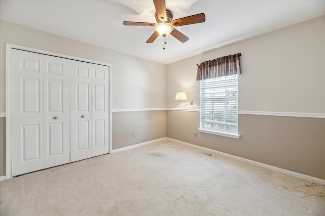 713 Mary Ann Dr, Holly, MI 48442 - unfurnished bedroom with carpet flooring, ceiling fan, baseboards, visible vents, and a closet