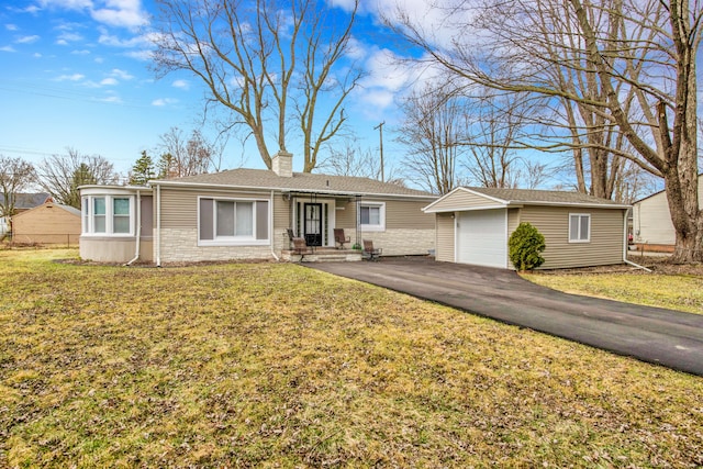ranch-style home with driveway, stone siding, an outdoor structure, a front yard, and a chimney