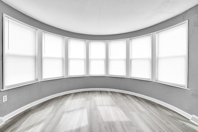 unfurnished sunroom with plenty of natural light