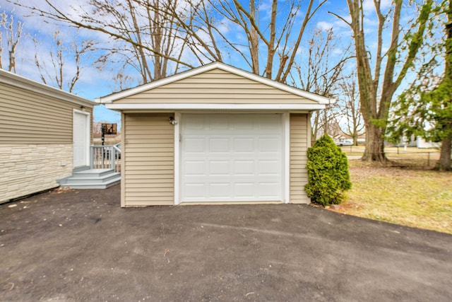 detached garage featuring aphalt driveway