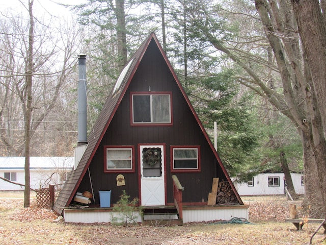5892 Woodland Dr, Lake, MI 48632 - a-frame style home featuring a shingled roof and entry steps