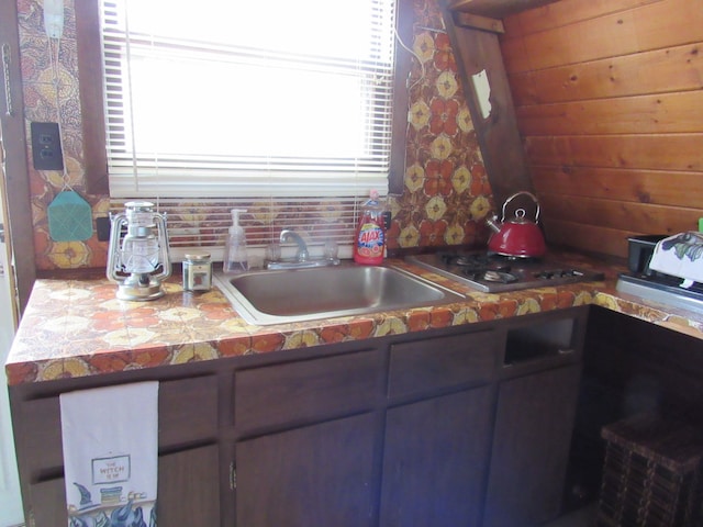 5892 Woodland Dr, Lake, MI 48632 - kitchen with stainless steel stovetop, a sink, and tile counters