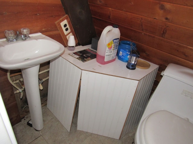 5892 Woodland Dr, Lake, MI 48632 - bathroom featuring washer / dryer, toilet, wood walls, and tile patterned flooring