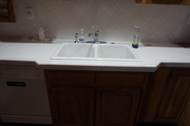 1758 Manor Rd, Au Gres, MI 48703 - kitchen featuring dishwasher, tile counters, backsplash, and a sink