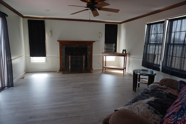 1758 Manor Rd, Au Gres, MI 48703 - living room featuring wood finished floors, a ceiling fan, baseboards, and ornamental molding