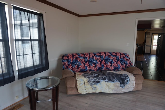 1758 Manor Rd, Au Gres, MI 48703 - living room featuring visible vents, wood finished floors, and ornamental molding