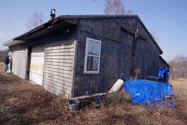 1758 Manor Rd, Au Gres, MI 48703 - view of side of property featuring a garage