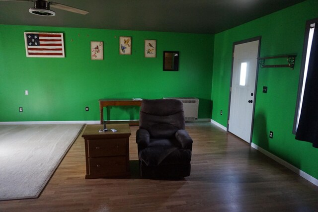 1758 Manor Rd, Au Gres, MI 48703 - living area with radiator heating unit, wood finished floors, baseboards, and ceiling fan
