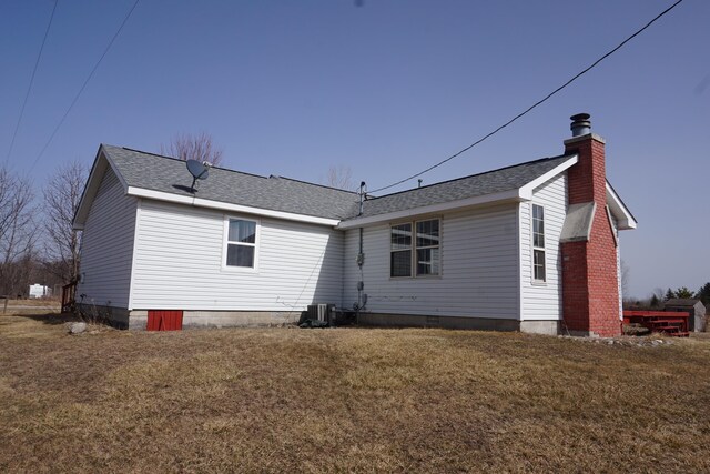 1758 Manor Rd, Au Gres, MI 48703 - rear view of house with a lawn, roof with shingles, and a chimney