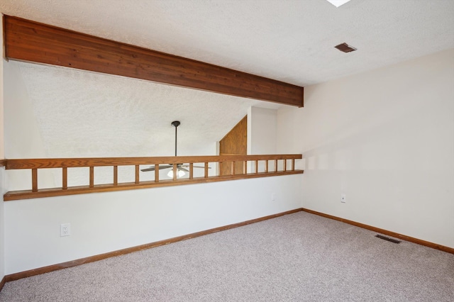 131 E Jolly Rd Unit E6, Lansing, MI 48910 - carpeted empty room featuring beamed ceiling, a textured ceiling, and baseboards