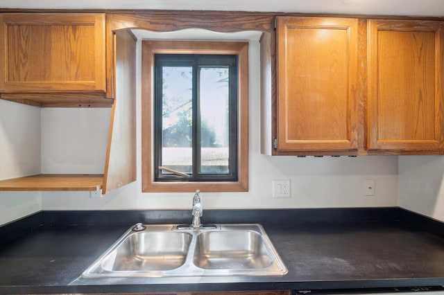 131 E Jolly Rd Unit E6, Lansing, MI 48910 - kitchen with a sink, dark countertops, brown cabinetry, and dishwashing machine